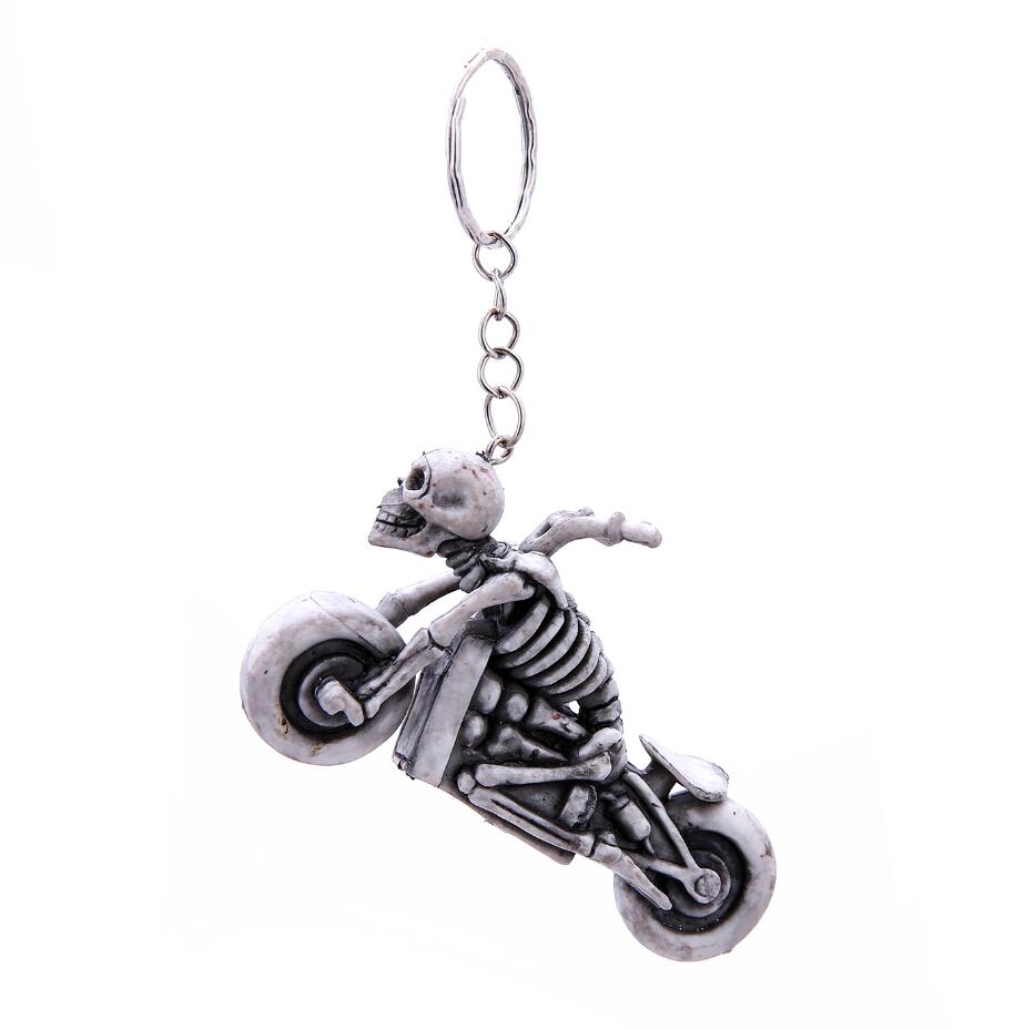 Skeleton man riding a motorcycle keychain